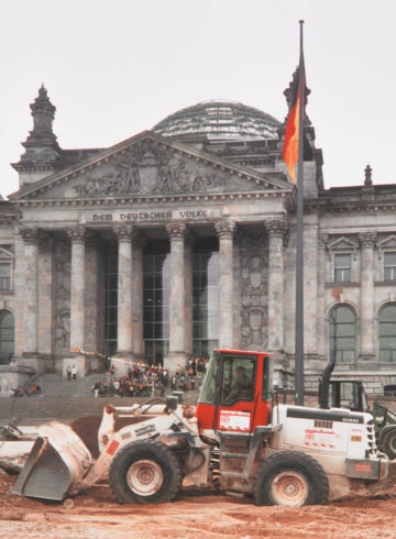 BTB excavator in front of the Berlin Reichstag building excavating earth