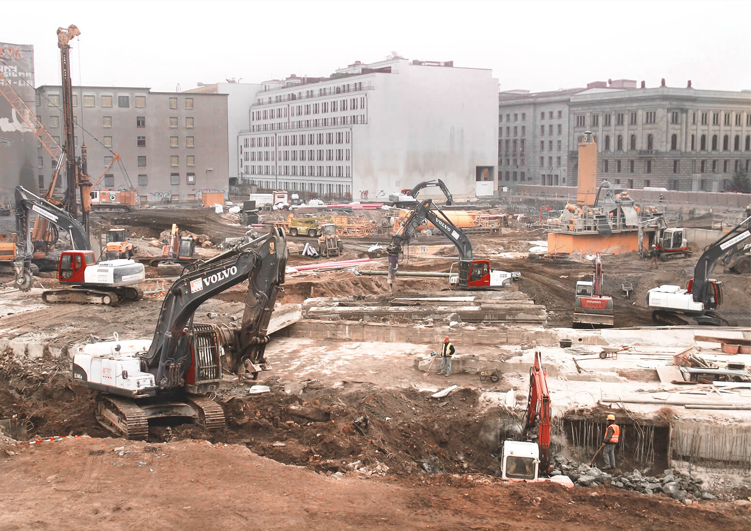 Numerous heavy vehicles with saws, hammers and shovels remove the concrete ceiling of the subway for the construction of the Mall of Berlin